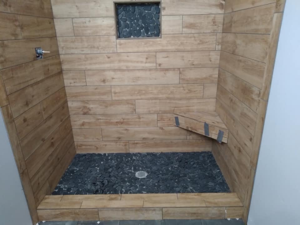Full bathroom remodel with dark marble tile installed in Brady TX — tile installation by Heart of Texas Flooring
