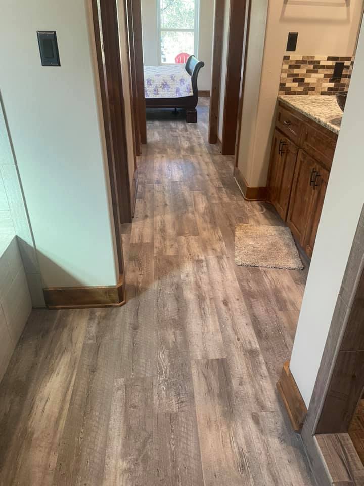 Waterproof luxury vinyl plank flooring installed in a hallway and bathroom in Goldthwaite TX by Heart of Texas Flooring