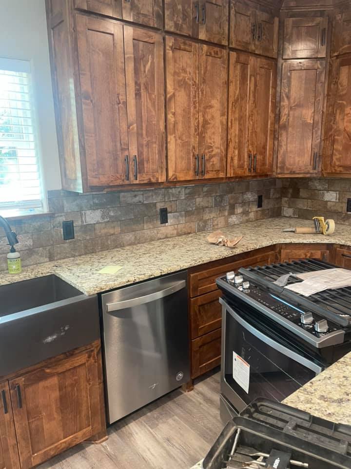 Natural stone tile backsplash and LVP floor installed in a kitchen in San Saba TX by Heart of Texas Flooring