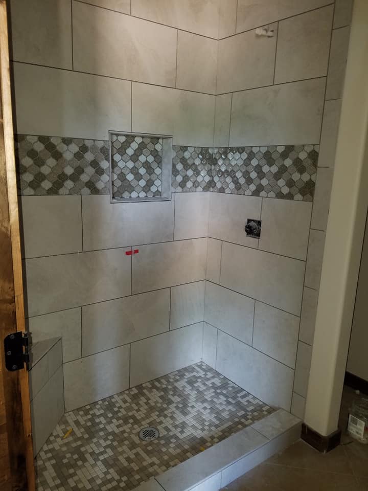 Custom tile shower with mosaic accent wall installed in Coleman TX — shower tile by Heart of Texas Flooring